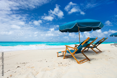Photo: Chairs and umbrella on tropical beach Chairs and umbrella on tropical beach