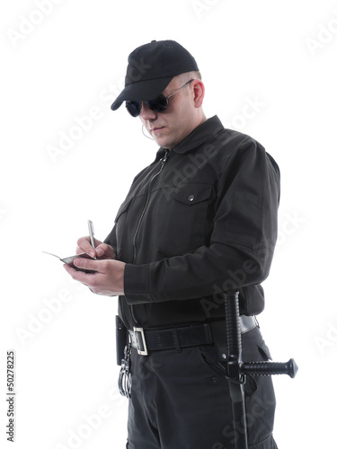 Photo: Policeman taking notes Policeman taking notes