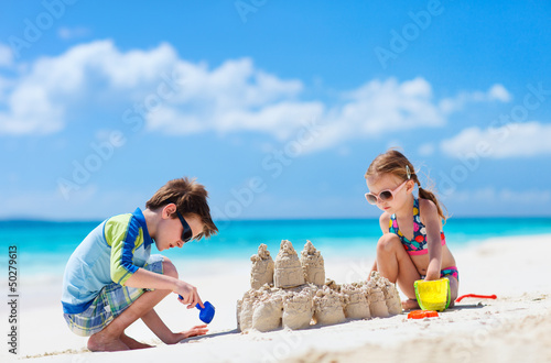 Photo: Two kids playing at beach Two kids playing at beach