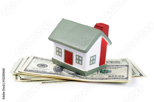 Photo: toy house for dollar banknotes as a background toy house for dollar banknotes as a background