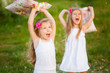 Two lovely girls playing on meadow