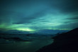 Northern lights above lagoon in Iceland
