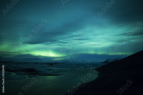 Photo: Northern lights above lagoon in Iceland Northern lights above lagoon in Iceland