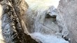 stream of water between the rocks in the mountains