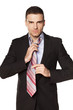 attractive businessman tied his tie before going to work