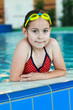 Schoolgirl with goggles in swimming pool