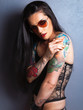 Young beautiful sexy brunette with gorgeous tattoo on her arms