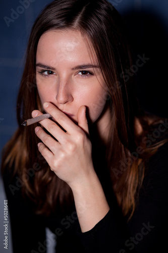 Photo: Young woman smoking a joint Young woman smoking a joint