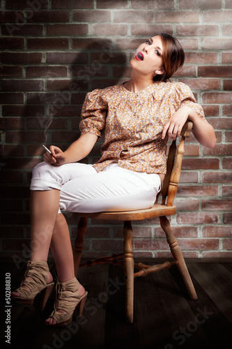 Photo: Grunge Girl Smoking Cigarette In Dark Interior Grunge Girl Smoking Cigarette In Dark Interior