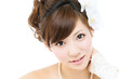 Beautiful asian woman dressed as a bride on white background