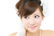 Beautiful asian woman dressed as a bride on white background