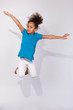 Photo: Portrait of Young African American girl jumping Portrait of Young African American girl jumping