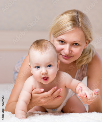 Photo: mother playing with baby boy indoors mother playing with baby boy indoors