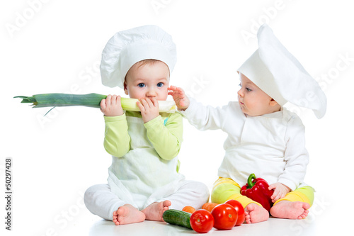 Photo: babies boy and girl wearing a chef hat with healthy food vegeta babies boy and girl wearing a chef hat with healthy food vegeta