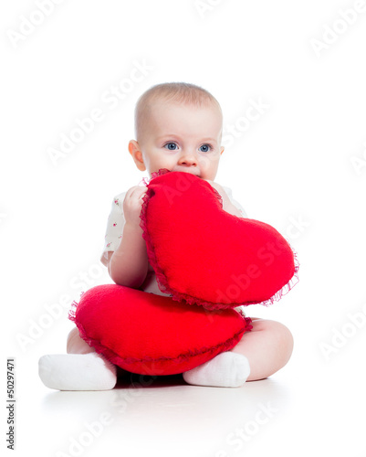 Photo: baby girl with pillow in heart shape baby girl with pillow in heart shape