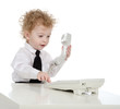 young businessman sitting at office desk on landline phone call