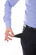 Young business man pulling out empty pocket.