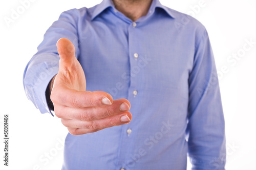 Photo: Young business man giving hand. Young business man giving hand.