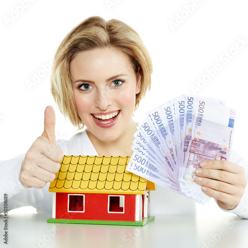 Photo: Woman has enough money for a house, shows thumb up Woman has enough money for a house, shows thumb up