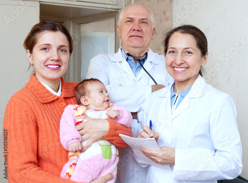 Photo: happy mother with baby and doctors happy mother with baby and doctors