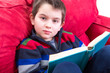 Photo: Kid Reading Book on the Couch Kid Reading Book on the Couch