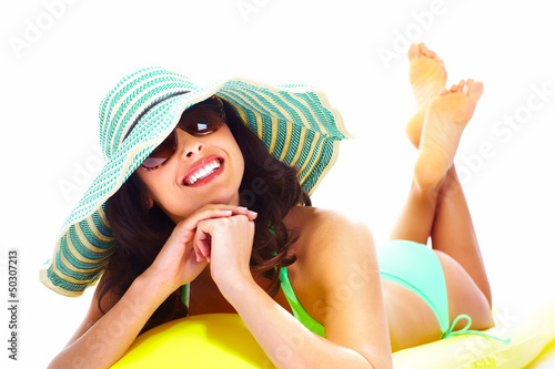 Photo: Woman relaxing on the beach. Woman relaxing on the beach.
