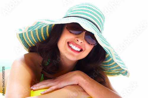 Photo: Woman relaxing on the beach. Woman relaxing on the beach.
