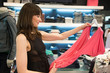 Young woman shopping for dresses