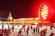 Red spotlight and people skate at GUM-Skating rink on Red Square
