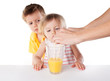 Children watch as pouring juice isolated on white