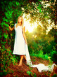 Beautiful girl in fairy forest near the river