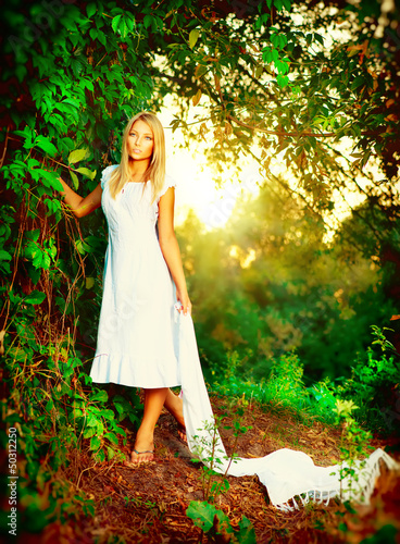 Photo: Beautiful girl in fairy forest near the river Beautiful girl in fairy forest near the river