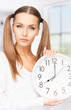 woman holding big clock