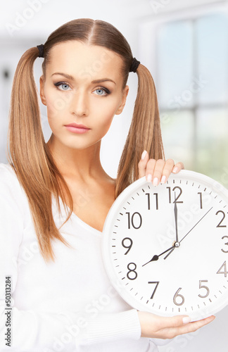 Photo: woman holding big clock woman holding big clock