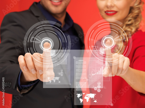 Photo: man and woman pressing virtual button man and woman pressing virtual button