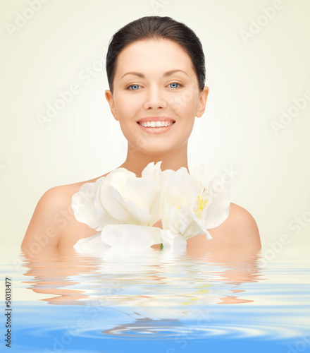Photo: woman with orchid flower in water woman with orchid flower in water
