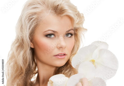 Photo: lovely woman with orchid flower lovely woman with orchid flower