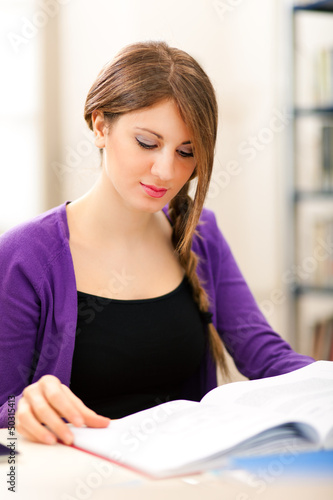 Photo: Young student reading a book Young student reading a book