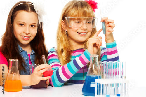 Photo: Two girls in chemistry class Two girls in chemistry class