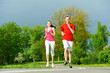 Young man and woman jogging outdoors