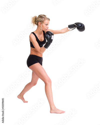 Photo: Young woman with boxing gloves at workout Young woman with boxing gloves at workout