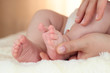 newborn baby feet on female hands