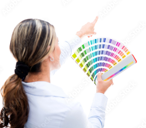 Photo: Woman choosing a color for the wall Woman choosing a color for the wall
