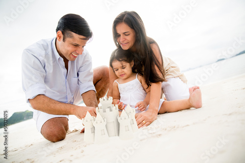 Photo: Family making sand castles Family making sand castles
