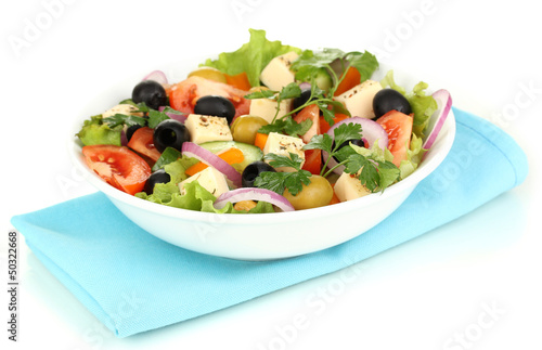 Photo: Greek salad in plate isolated on white Greek salad in plate isolated on white