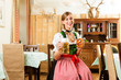 Frau in Bayerischer Tracht in Restaurant