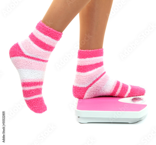 Photo: Feet on scales isolated on white Feet on scales isolated on white