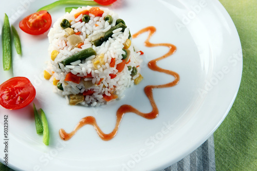 Photo: Delicious risotto with vegetables on table Delicious risotto with vegetables on table