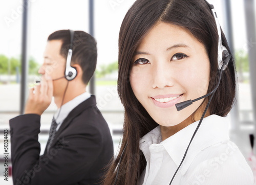 Photo: beautiful smiling businessman with call center agent beautiful smiling businessman with call center agent