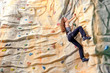 woman on rock wal